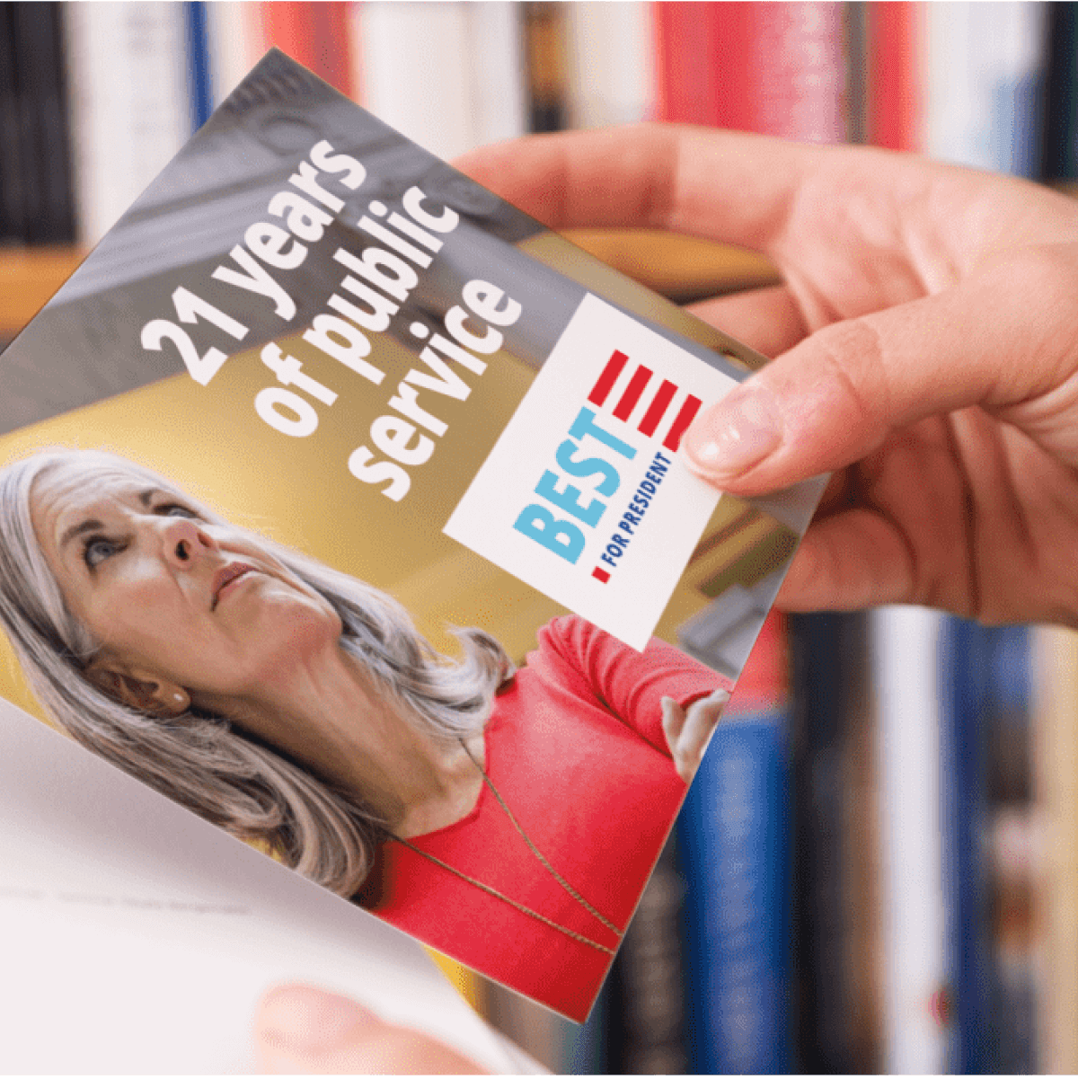 Close up of a woman’s hands holding a campaign mail piece promoting a candidate.