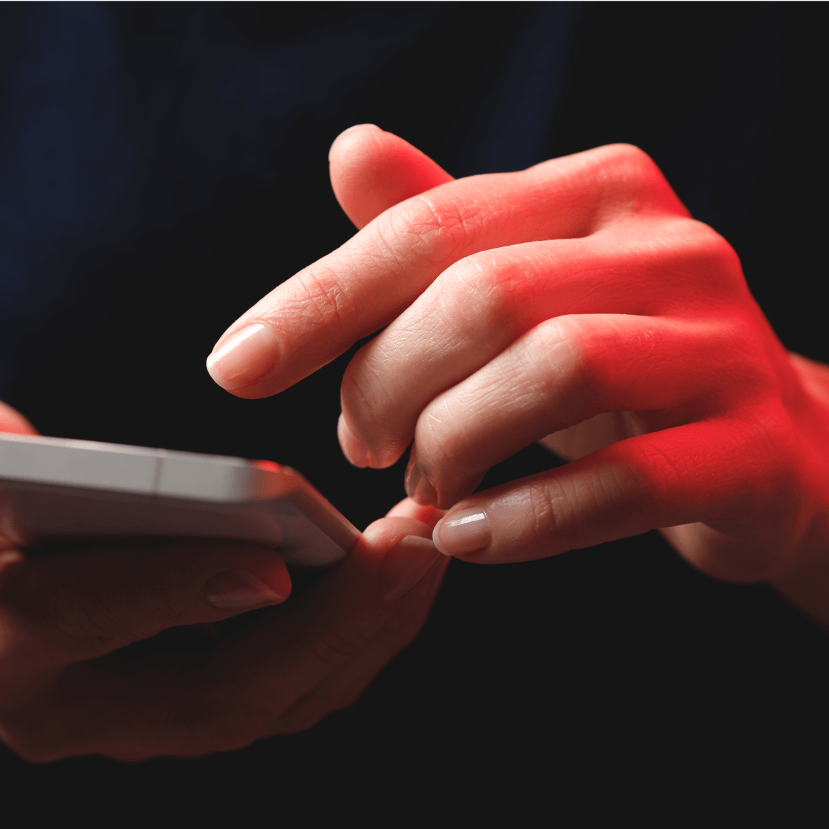 Close up of hands holding a smartphone.