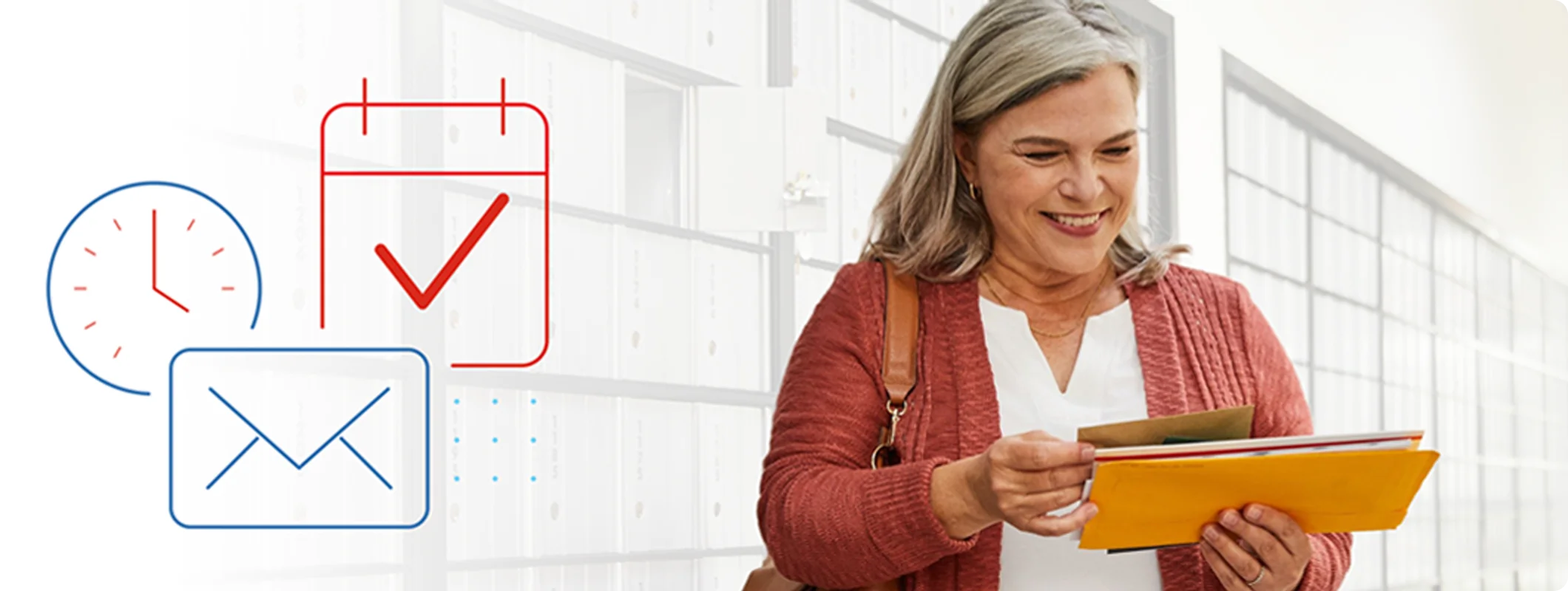 Woman smiling while standing in front of a wall of cluster mailboxes looking down at the mail in her hands.